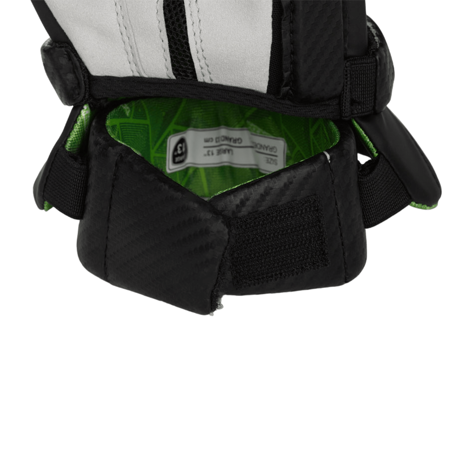 Close-up of the Maverik 3003090 Glove, highlighting its classic fit with a sleek black and white design. The open cuff includes a velcro strap, and the interior features a quickdry liner in green with a size label. It is displayed against a matching green background for a uniform appearance.