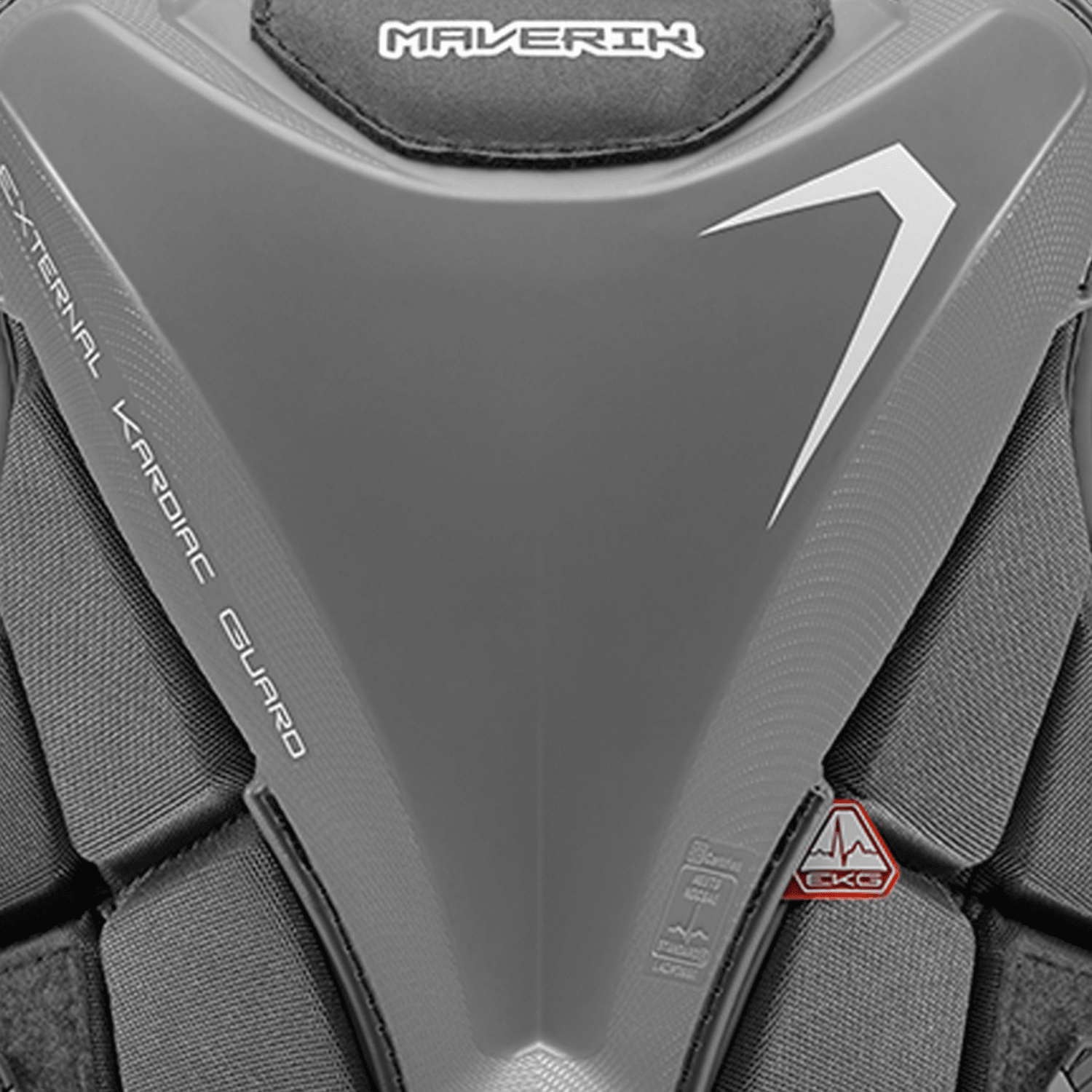 A close-up of the Maverik MX EKG Goalie Chest Pad from Maverik showcases its gray protective sports chest guard specifically designed for goalies. The chest pad features bold text stating "External Cardiac Guard" alongside a triangular logo. It meets the NOCSAE Performance Standard ND200 and boasts a sleek, angular design with side padding for EKG protection, ensuring robust construction.