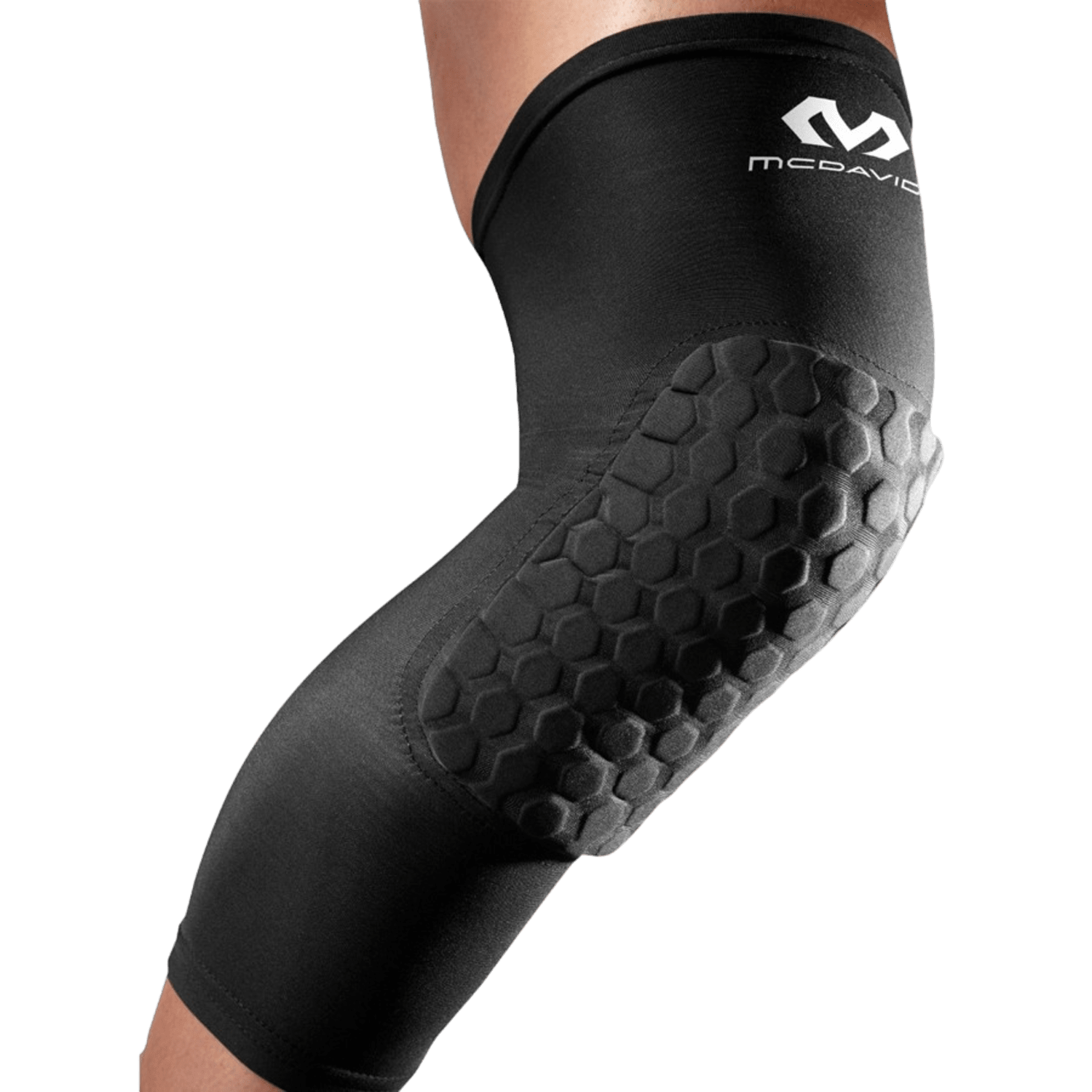 A person is wearing a black knee brace featuring a hexagonal padded design on the knee area. These McDavid Hex Leg Sleeves offer support and protection for athletic activities, ensuring you remain prepared for any face-off with confidence and stability.