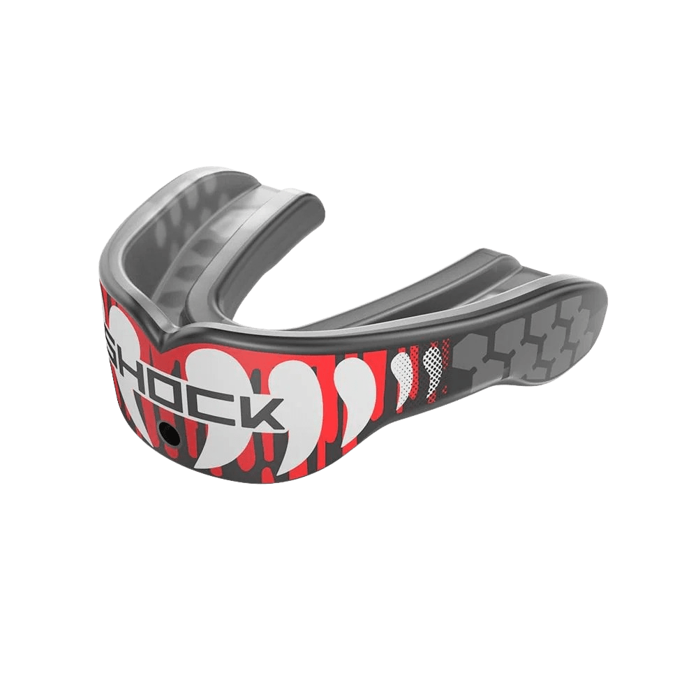 Introducing the ShockDoctor Gel Max Power Print Mouthguard, a ruggedly designed piece perfect for impact sports. It features gray and red camo patterns with "SHOCK" boldly displayed on the front center. Enjoy a custom fit that guarantees both comfort and protection.