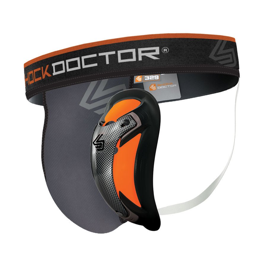 The ShockDoctor Ultra Pro Supporter with Ultra Carbon Flex Cup boasts a vibrant orange, black, and gray design that prioritizes comfort. It includes a waistband, support straps, and a durable hard shell for maximum protection. The "Shock Doctor" logo is prominently displayed on the waistband, making it an essential supporter for athletes.