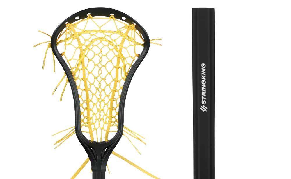 A close-up of a StringKing Complete Composite Tech Trad Complete Stick, featuring a black shaft and yellow netting on the head. The handle, labeled with "Stringking," is prominently displayed next to the head.